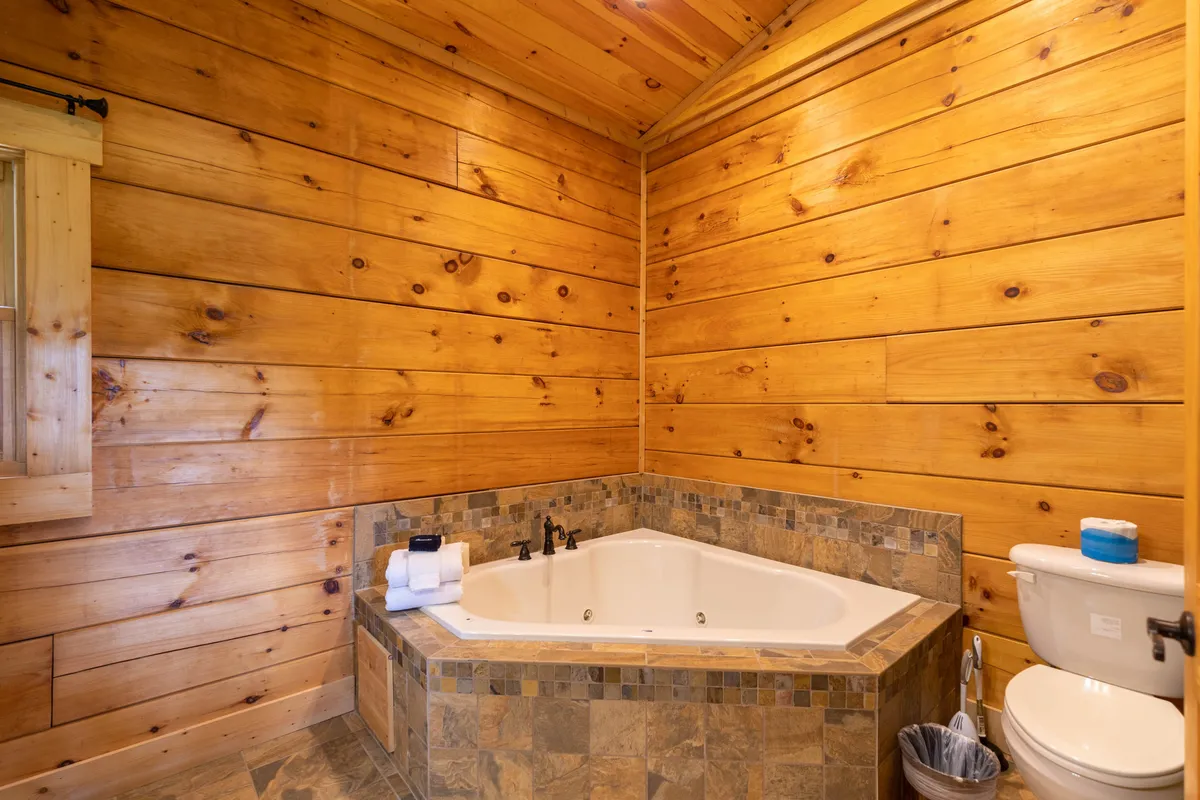 A tranquil bathroom scene with a luxurious jacuzzi tub, wood paneling, and neatly arranged towels. The space feels rejuvenating, perfect for unwinding after a busy day.